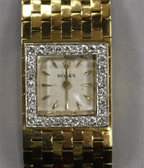 A ladys late 1950s 18ct gold and diamond set Rolex manual wind bracelet watch, retailed by Kutchinsky, London.